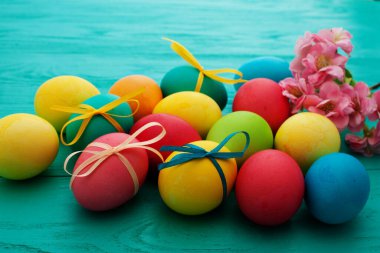 colorful easter eggs top view on blue chalkboard copy space