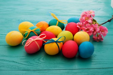 colorful easter eggs top view on blue chalkboard copy space