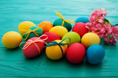 colorful easter eggs top view on blue chalkboard copy space