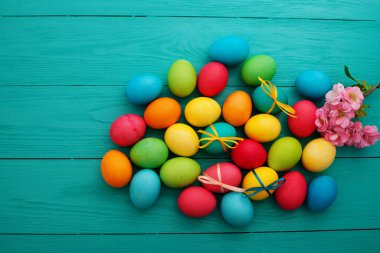 colorful easter eggs top view on blue chalkboard copy space