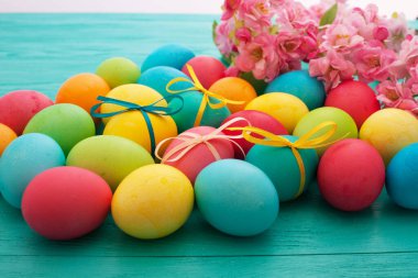 colorful easter eggs top view on blue chalkboard copy space