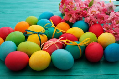colorful easter eggs top view on blue chalkboard copy space