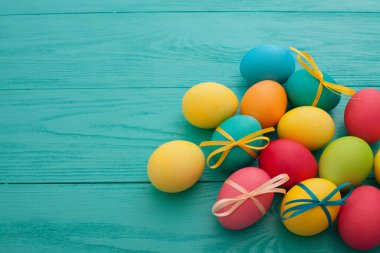 colorful easter eggs top view on blue chalkboard copy space