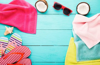 Summer accessories for modern woman on her vacation. Top view. Blue wooden background