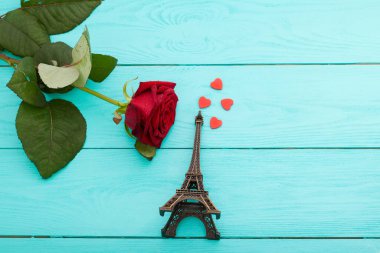 paris travel concept - rose, eiffel tower souvenir on blue chalkboard top view