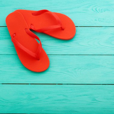 red flip flops on blue wooden background top view free space