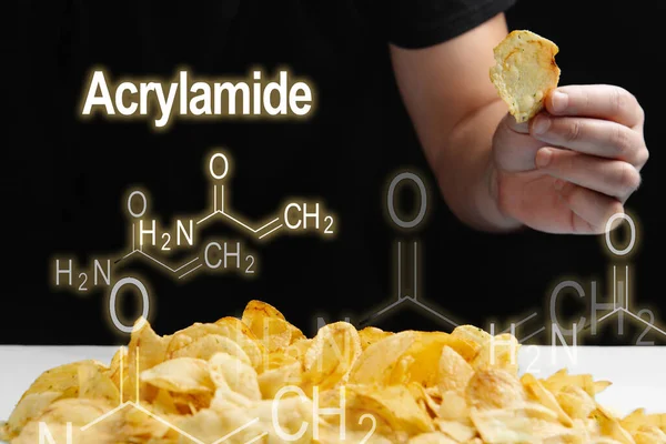 stock image Man eat fried foods, chips high in Acrylamide. Acrylamide formula on a black background.