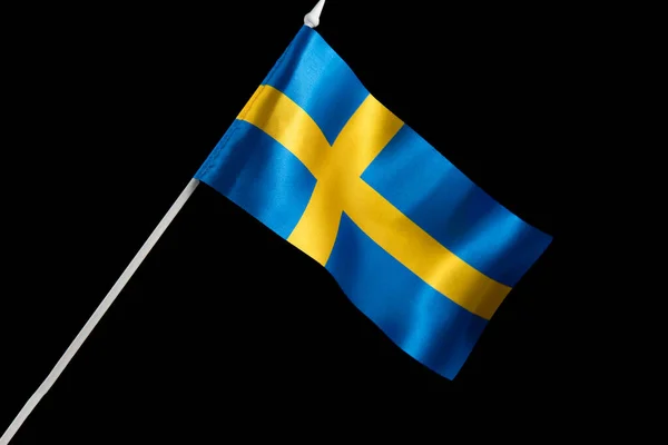 Sweden flag waving. The flag of Sweden on a black background is developing and flying in the wind