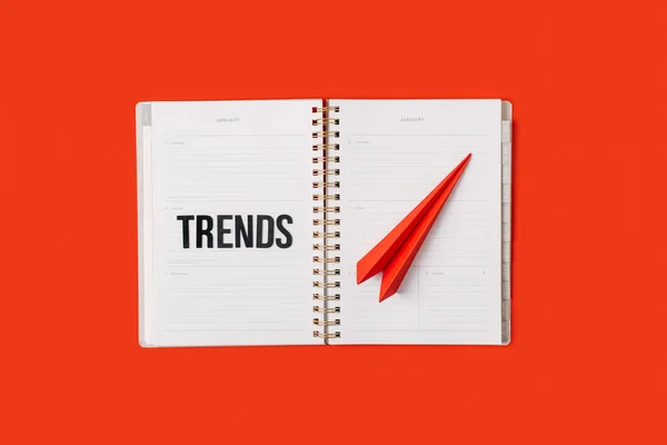Technology Trends, Tech trends, Top New Technology. Word trends on open notepad with different gadgets and devices on red background