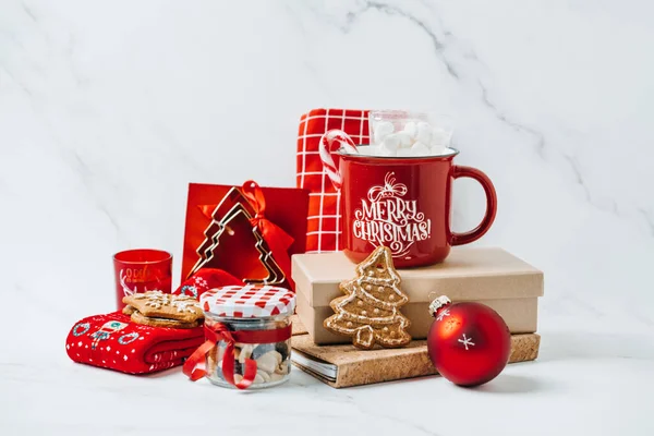Sustainable christmas Gifts, Eco-Friendly Holiday Xmas Gift Ideas. Red and brown zero waste cup, shopper bag, socks, notepad, sweets, cookies on table.