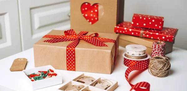 Christmas Gift Wrap Boxes and Supplies. Red brown Xmas Gift box, kraft paper shopping bag and ribbons for wrapping. Sustainable Eco-Friendly zero waste Christmas Gift Wrap