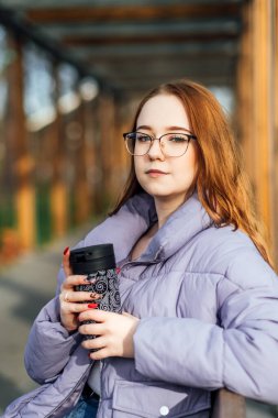 Spring, self love, self care. Candid portrait of happy relaxed woman outdoors. Happy woman relaxing in the park on a sunny day.