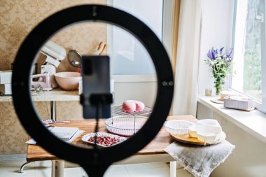 Online classes and workshops on cake decorating and baking. Female Confectioner baker make custom pink heart shape cake in kitchen Bakery