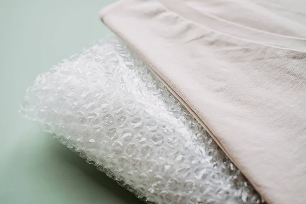 Recycle clothes concept. Recycling Fibers in the Textile Industry. Sustainable recycled cotton fiber. Recycled cloth T-shirt and bubble wrap plastic.