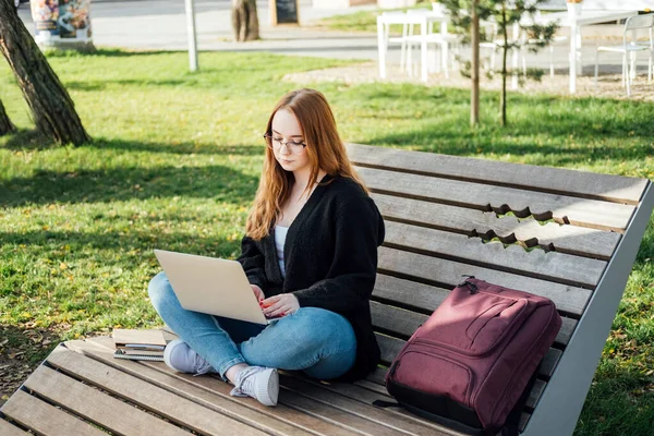 Artificial Intelligence AI in education industry. Applications of Artificial Intelligence and chatbots in Education. Student girl with laptop using chatbot for studying process.