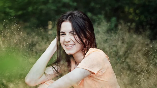 stock image Candid portrait of beautiful happy smiling young woman with braces in summer park. Outdoor portrait of attractive girl bracket system. Brace, dental care, orthodontic health