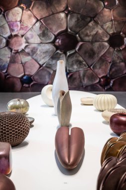 Henryk Lula's exhibition features a diverse range of ceramic forms, from shells to jugs, showcasing mastery in glazing, color, and texture exploration. clipart
