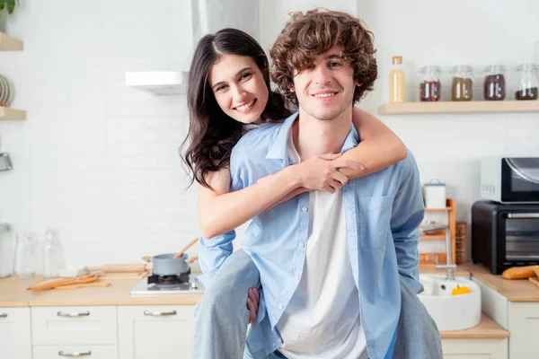 Portrait lovely cute young couple with beaming smiles Young affectionate couple happily spending time together in cozy modern kitchen at home Happy Beautiful Woman and Handsome Man rest chin on hands