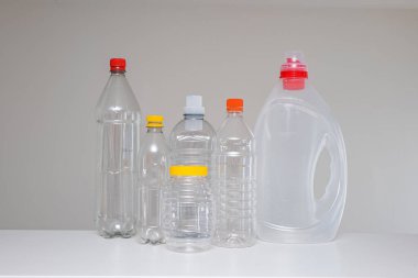 Variety of empty transparent plastic bottles without a label, ready to be recycled. Close up studio shot, no people