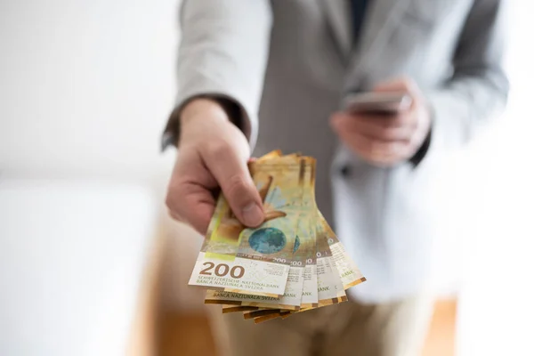 Unrecognizable Man Casual Suit Holding Out Banknotes 200 Swiss Francs — Stock Photo, Image