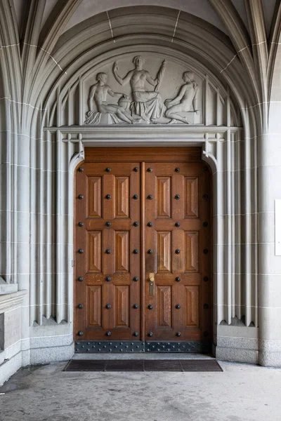 Stock image Old very large wooden entry brown door or gate. Decorated building arches, medieval european architecture, no people.