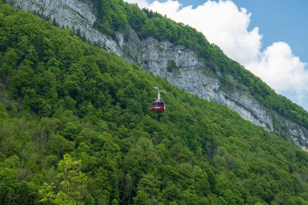 stock image Large red funicular cabin taking tourists up the mountain in the Swiss Alps.