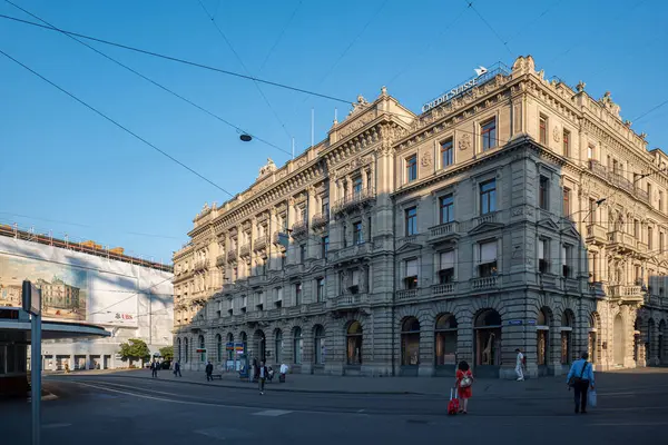 stock image 28-08-2024 Zurich, Switzerland. Credit Suisse bank headquarters at Paradeplatz on Bahnhofstrasse. Wide angle street point of view, sunny summer morning, pedestrians commuting.