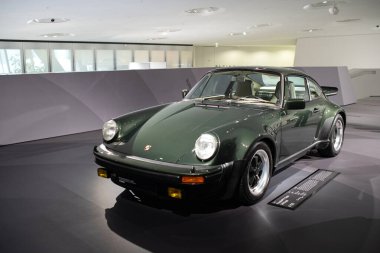 14-09-2024, Stuttgart, Germany. Porsche Museum.. 1976 Type 930 Porsche 911 turbo 3.0 coupe in green. clipart