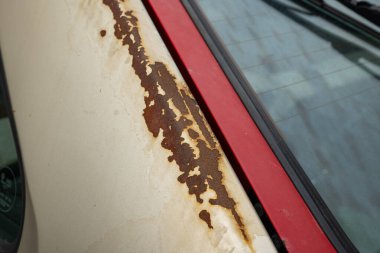 Eski, paslı araba gövde panelleri. Eski bir arabanın pas bantlarını yakın çekim, insan yok..