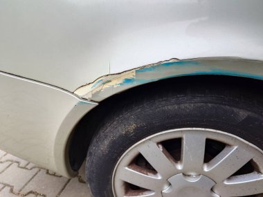 Çökmüş ve paslanmış araba tekerleği kemeri. Yakın çekim, insan yok..