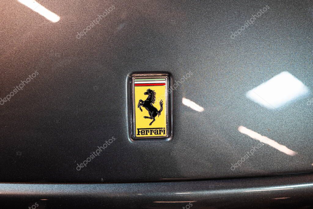 Ferrari prancing horse iconic hood ornament emblem or badge. Top down, close up detail view, no people, gray bonnet