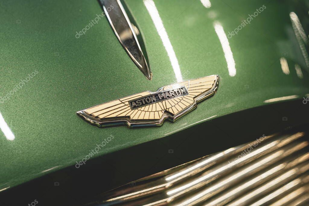 08-06-2025, Kempttal, Switzerland.Aston Martin hood or bonnet ornament emblem or badge on a youngtimer car. Top down, close up detail shot, no people