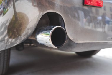 Araba motoru tek egzoz metal uçlu. Arka tamponun yanında yakın çekim.