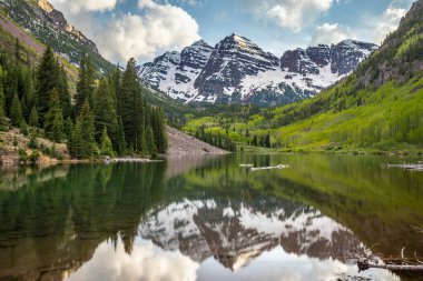 Maroon Gölü 'ndeki görkemli Maroon Bells' in yansımaları parlak güneşli bir günde Aspen, Colorado 'da çarpıcı bir manzara yaratır..