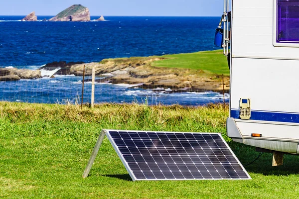 stock image Portable solar photovoltaic panel, charging battery at camper vehicle.