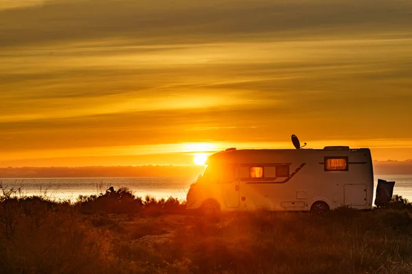 太陽が海の地平線の上に上昇し キャンパーRvビーチの海岸でキャンプ スペインでの休暇 モーターホームでの旅行 — ストック写真