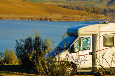 Caravan camping on nature, countryside surrounding lake Embalse del Guadalhorce, Ardales Reservoir, Malaga Andalusia, Spain. clipart