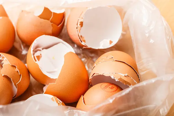 Kitchen food products details concept. Many empty cracked eggshells left after cooking.