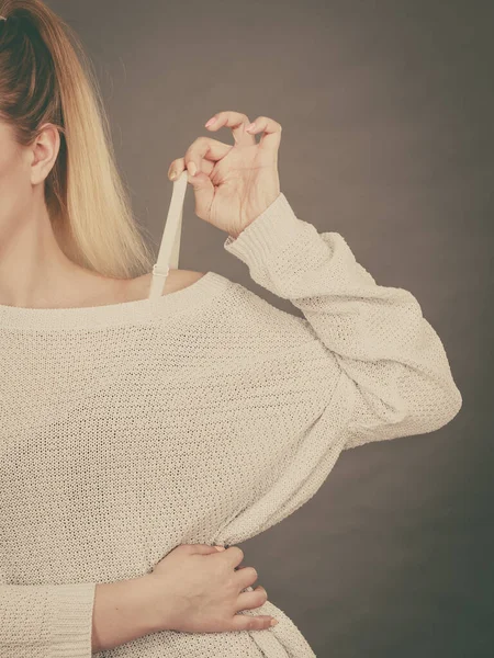 Woman Holding Her Bra Strap Her Sweater Brafitting Concept Grey — Stock Photo, Image