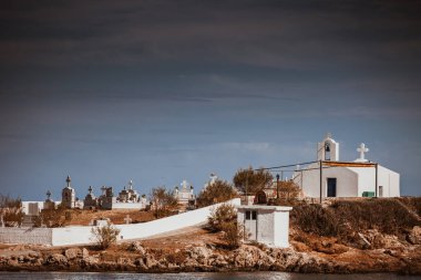 Agios Fokas near Monemvasia. Small cemetery graveyard on sea shore in Laconia region Peloponnese. clipart