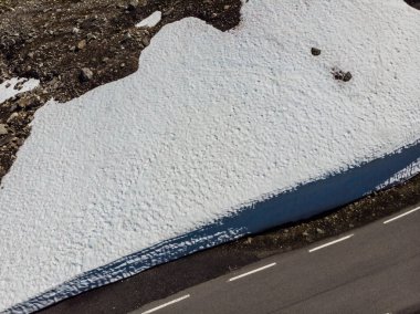 Aerial view. Asphalt road and snow wall on roadside norwegian mountains,, Aurlandsvegen Norway clipart