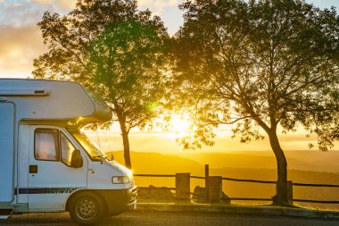 Caravan in the morning camping in mountains at Penedo Durao lookout, north Portugal. Traveling by motorhome. clipart