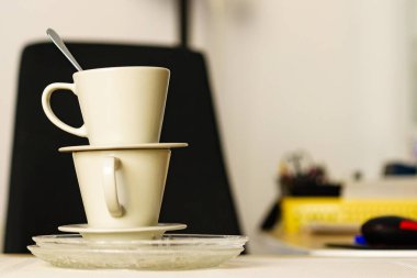 Two empty dirty cups after coffee drinking on table desk. Messy interior. clipart