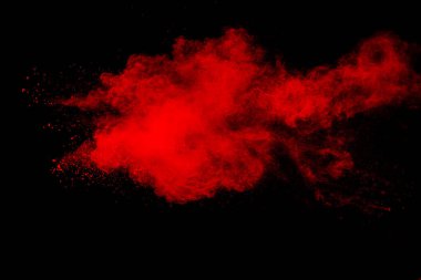 Red powder explosion on black background.  Freeze motion of red color dust  particles splashing.