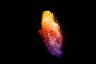 Colorful dust particles textured background.Multicolored powder explosion on black background.