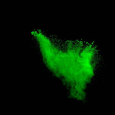Green dust explosion on black background. Colored powder splatter on background.