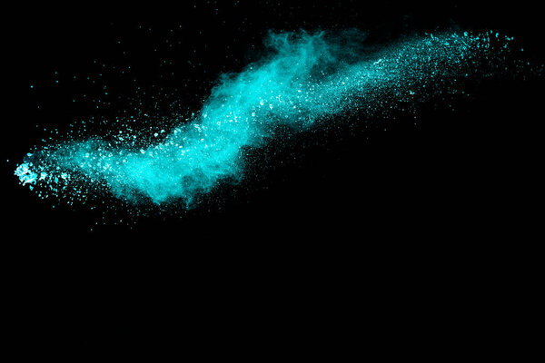Splash of green colored powder on black background.Green powder explosion.