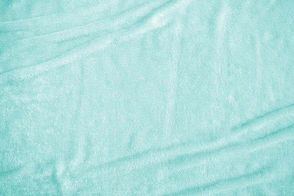 Teal blue velvet background or turquoise green velour flannel texture made of cotton or wool with soft fluffy velvety satin fabric cloth metallic color material