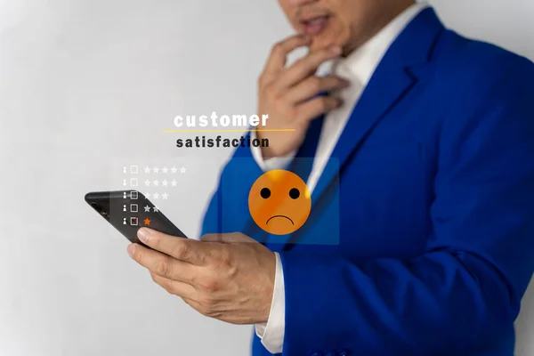 Customer Experience dissatisfied Concept, Unhappy Businessman Client with Sadness Emotion Face on smartphone screen, Bad review, bad service dislike bad quality, low rating, social media not good.