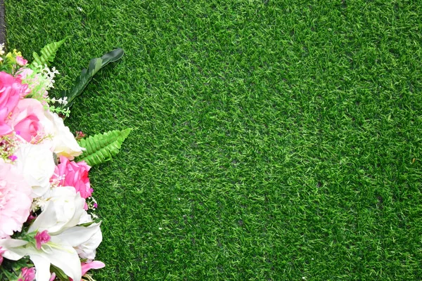 Combination of plants, artificial grass. Beautiful wall from various artificial creeper plant for background.staircase green artificial grass with pink flower.
